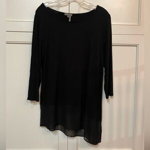Small black Vince Camuto asymmetrical top with sheer material at bottom.